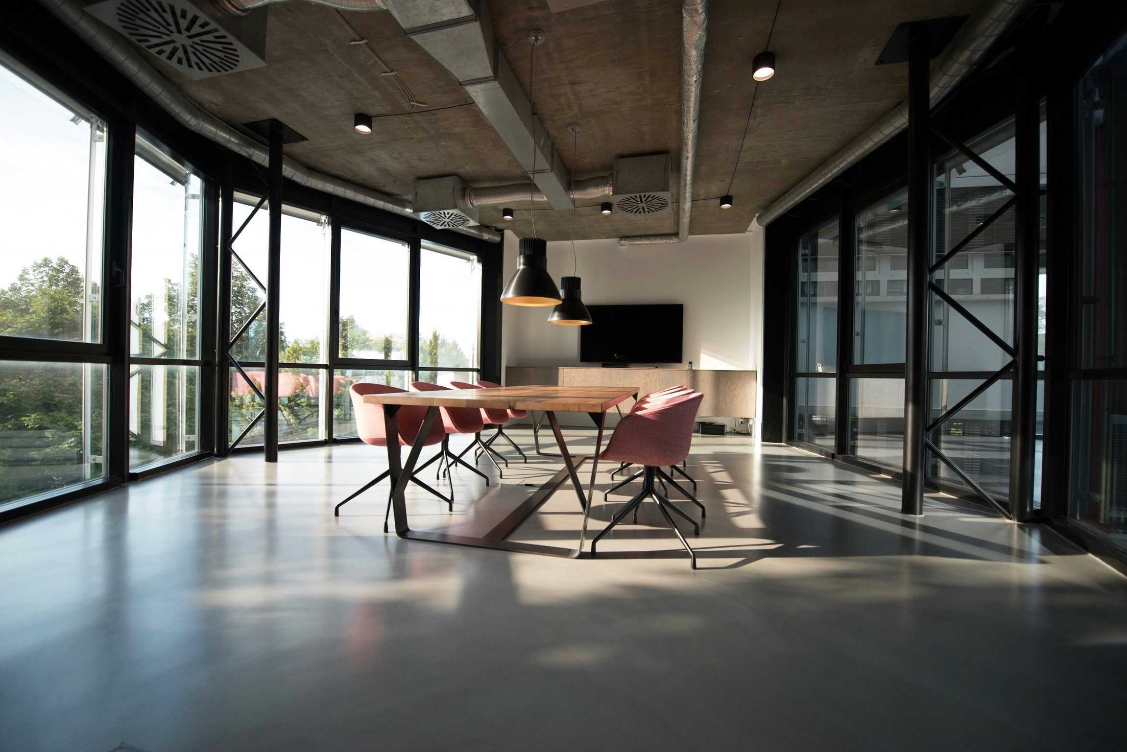 A sunlit boardroom with a long table and chairs — where William & Co sits alongside founders to back and build the business together